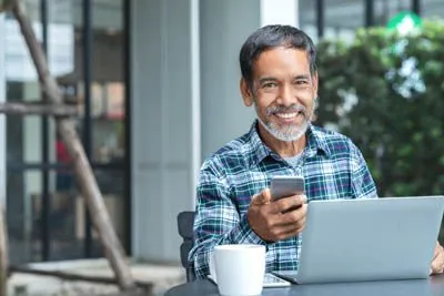 man scheduling a dental appointment at Optima Dental