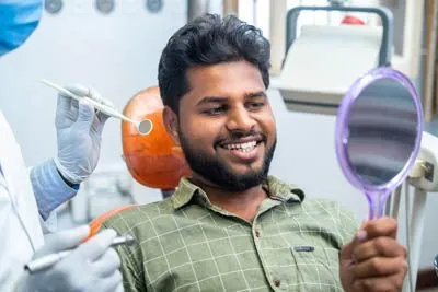 man smiling with his new dental implants from Optima Dental in Lawrenceville, GA