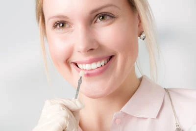 woman choosing a color for her dental veneers