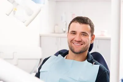 man smiling in the dental chair at Optima Dental