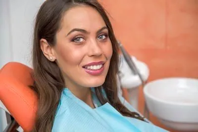 woman smiling in the dental chair at Optima Dental