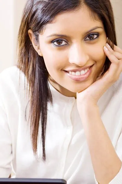 woman smiling after her oral surgery at Optima Dental