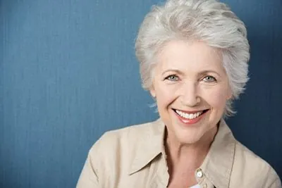 woman smiling with mini dental implants
