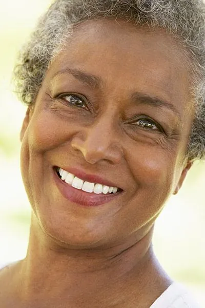 woman smiling after getting restorative dental care at Optima Dental