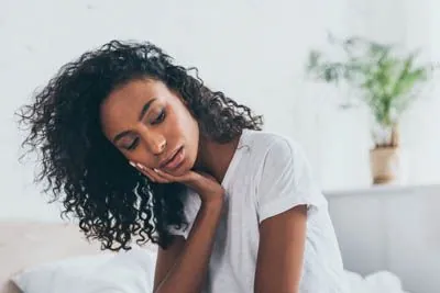 woman needing an emergency dental appointment due to tooth pain