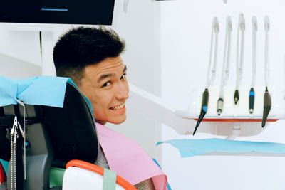 man getting his teeth cleaned at Optima Dental