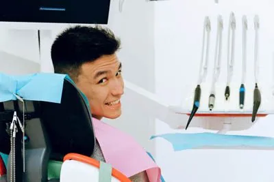 man getting his teeth cleaned at Optima Dental